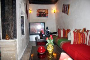 a living room with a couch and a table at Riad Chakir Mogador in Essaouira