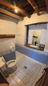 a bathroom with a toilet and a sink and a mirror at Feelgood dive resort in Basbas +45 photos