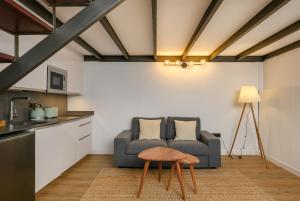 a living room with a couch and a table at MÁ HOMES Postigos in Málaga