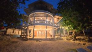a large house with a tree in front of it at Feelgood dive resort in Basbas