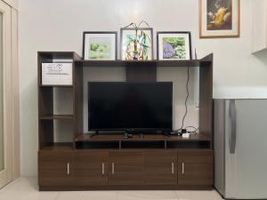 a entertainment center with a flat screen tv at Sea Residences in Manila
