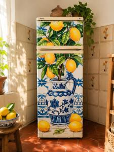 a blue and white vase with a plant in it at Limonaia in Villa Viani