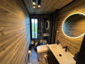 a bathroom with a sink and a toilet and a mirror at Hyggeli in Vadsø +11 photos