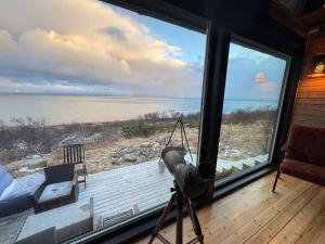 a view of the beach from a room with a large window at Hyggeli in Vadsø
