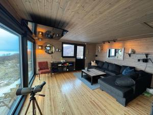 a living room with a couch and a table at Hyggeli in Vadsø