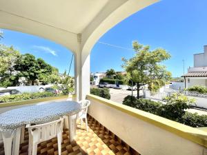 a balcony with a table and chairs and a view of a street at CASA CALIPSO - Casa a pochi passi dal mare delle Maldive del Salento in Salve