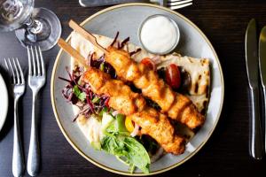 a plate of food with fish sticks and a salad at Lanhydrock Hotel & Golf Club in Bodmin