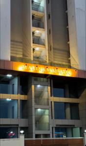 a building with a sign on the side of it at Luxe Kochi Flat Backwater Views in Cochin