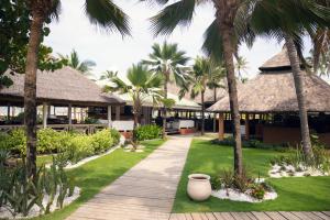 a resort with palm trees and a walkway at Casa Del Papa Resort in Ouidah