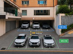 a group of cars parked in a parking lot at Unicorn Family Residence Seoul in Seoul