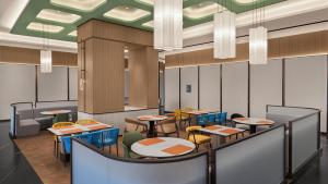 a rendering of a restaurant with tables and chairs at Holiday Inn Bayanbulak by IHG in Bayanbulak
