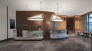 a lobby of a hotel with a reception desk at Holiday Inn Bayanbulak by IHG in Bayanbulak