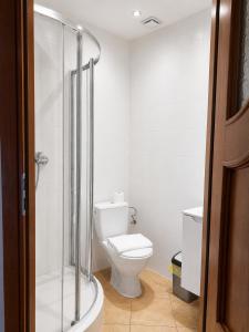 a bathroom with a toilet and a glass shower at Belona in Stegna