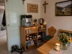 a kitchen with a table and a coffee maker on a shelf at Zuhause am Bach Ruhige Unterkunft für Erholungssuchende am Welterbesteig und Donauradweg in Aggsbach +14 photos