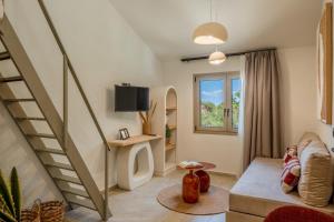 a living room with a staircase and a tv at Soluna Forte Sea Living Suites in Palaiokastro