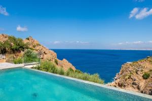 a swimming pool with a view of the ocean at Soluna Forte Sea Living Suites in Palaiokastro