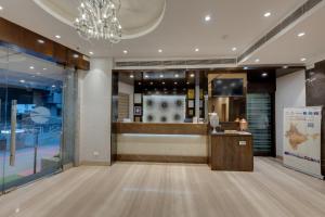 a lobby of a store with a chandelier at Hotel Suba Galaxy Mumbai in Mumbai