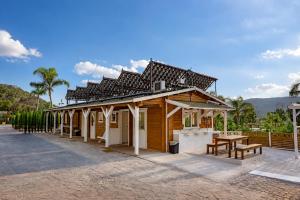 a wooden building with a table and a picnic table at Kampaoh Cova Negra in Gandía