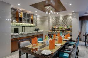 a dining room with a long table and chairs at Hotel Suba Galaxy Mumbai in Mumbai
