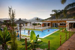 a resort pool with people playing in it at Kampaoh Cova Negra in Gandía