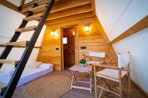 a room in a log cabin with a bed and a table at Kampaoh Cova Negra in Gandía +66 photos