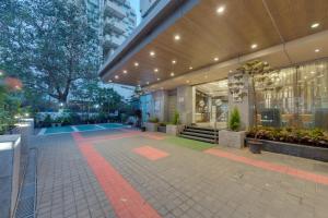 a building with a walkway in front of it at Hotel Suba Galaxy Mumbai in Mumbai