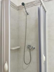 a shower with a shower head in a bathroom at CASA CALIPSO - Casa a pochi passi dal mare delle Maldive del Salento in Salve +60 photos