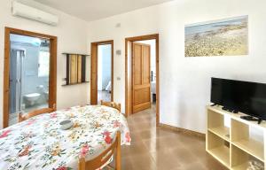 a living room with a table and a television at CASA CALIPSO - Casa a pochi passi dal mare delle Maldive del Salento in Salve