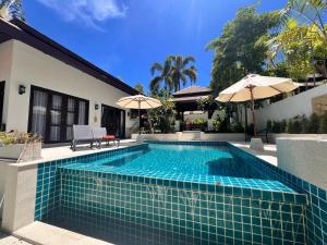 a swimming pool in the backyard of a house at Villa Mirada Maenam - Renovated Four Bedroom with Private Pool in Nathon Bay