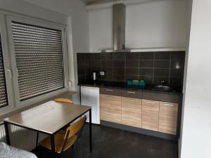 a kitchen with a table and a sink and a table and chairs at Monteurzimmer Drei Gleichen in Günthersleben +18 photos