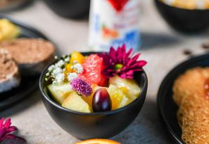 a bowl of fruit with a flower in it at B&B HOTEL Amiens Sud in Amiens
