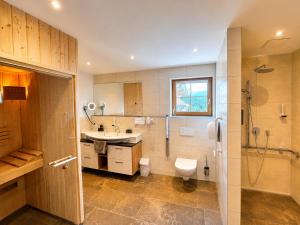 a bathroom with a sink and a toilet and a shower at Jaga Alm in Zell am See +72 photos