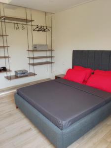 a bedroom with a large bed with red pillows at sidi yahia,hydra in Hydra