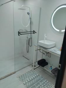 a white bathroom with a shower and a sink at sidi yahia,hydra in Hydra +49 photos