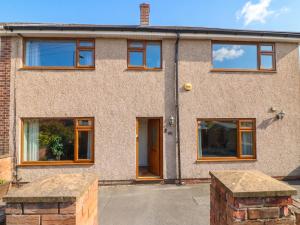 a brick house with wooden windows and a driveway at 57 Howden Avenue in Doncaster