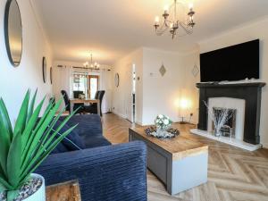 a living room with a couch and a fireplace at 57 Howden Avenue in Doncaster
