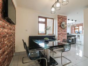 a dining room with a glass table and chairs at 57 Howden Avenue in Doncaster