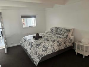 a bedroom with a bed with a teddy bear on it at Tranquillity by the sea in Killarney