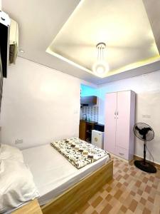 a room with a bed and a table and a chair at The Hideout in Lagos