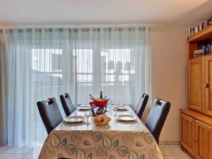 a dining room with a table and chairs and a window at Apartment Luchre by Interhome in Zermatt +16 photos