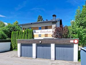a garage in front of a building at Apartment Am Birkenhain-28 by Interhome in Seefeld in Tirol