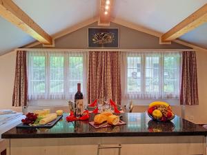 a kitchen with a table with fruit on it at Apartment Chalet Schwendihus-11 by Interhome in Grindelwald