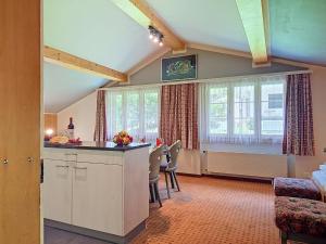 a kitchen and dining room with a table and chairs at Apartment Chalet Schwendihus-11 by Interhome in Grindelwald