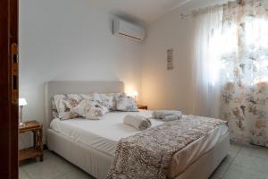 a bedroom with a bed with towels on it at Casa Stella Di Madel in Flumini di Quartu