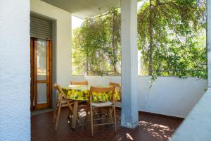 a table and chairs on the porch of a house at Kronos House in Torre del Lago Puccini