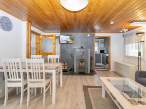 a living room with a table and a fireplace at Holiday Home Järvelä by Interhome in Kemijärvi