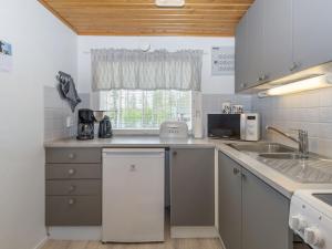 a kitchen with a sink and a counter top at Holiday Home Järvelä by Interhome in Kemijärvi