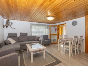 a living room with a couch and a table at Holiday Home Järvelä by Interhome in Kemijärvi