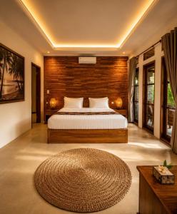 a bedroom with a bed and a large rug at Namali Private Villa in Gili Trawangan +24 photos