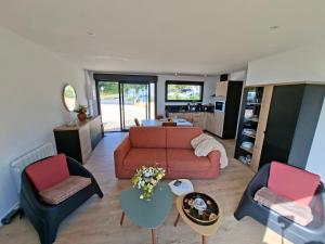 a living room with a couch and two chairs at Le chalet Ker Yann Vue mer Locquirec in Locquirec